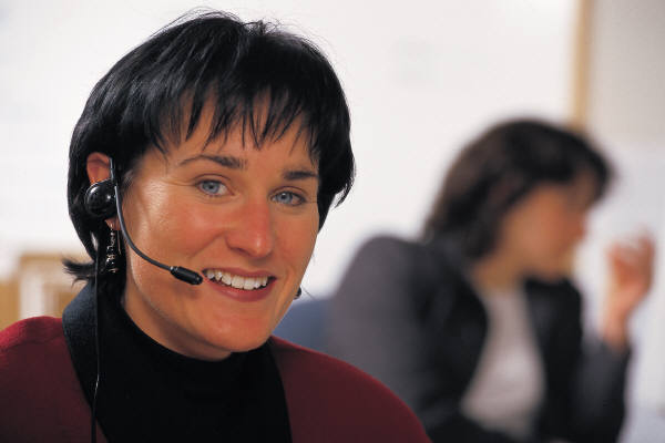 woman with headset looking at the viewer