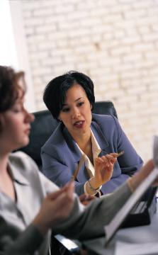 two women talking at a table
