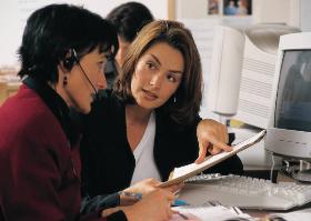 two women looking at computer screen