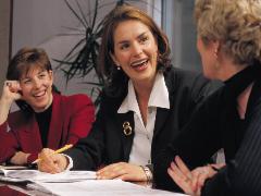 three women talking at a table