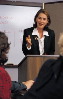 woman at podium speaking to a crowd