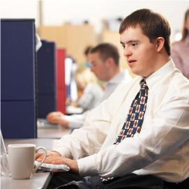 Young man with a disability sitting at his desk.
