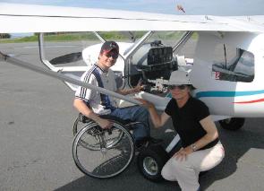 Person in a wheelchair about to enter a private plane.